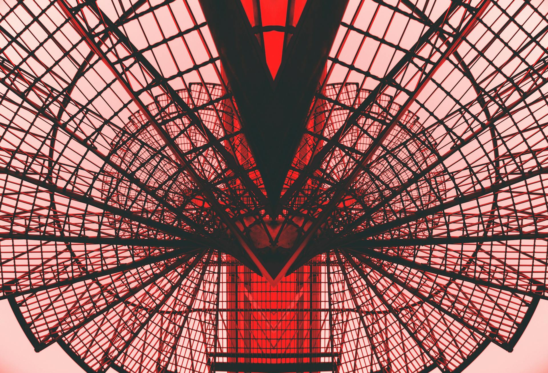 A creative photo of a complex red metal tower.
